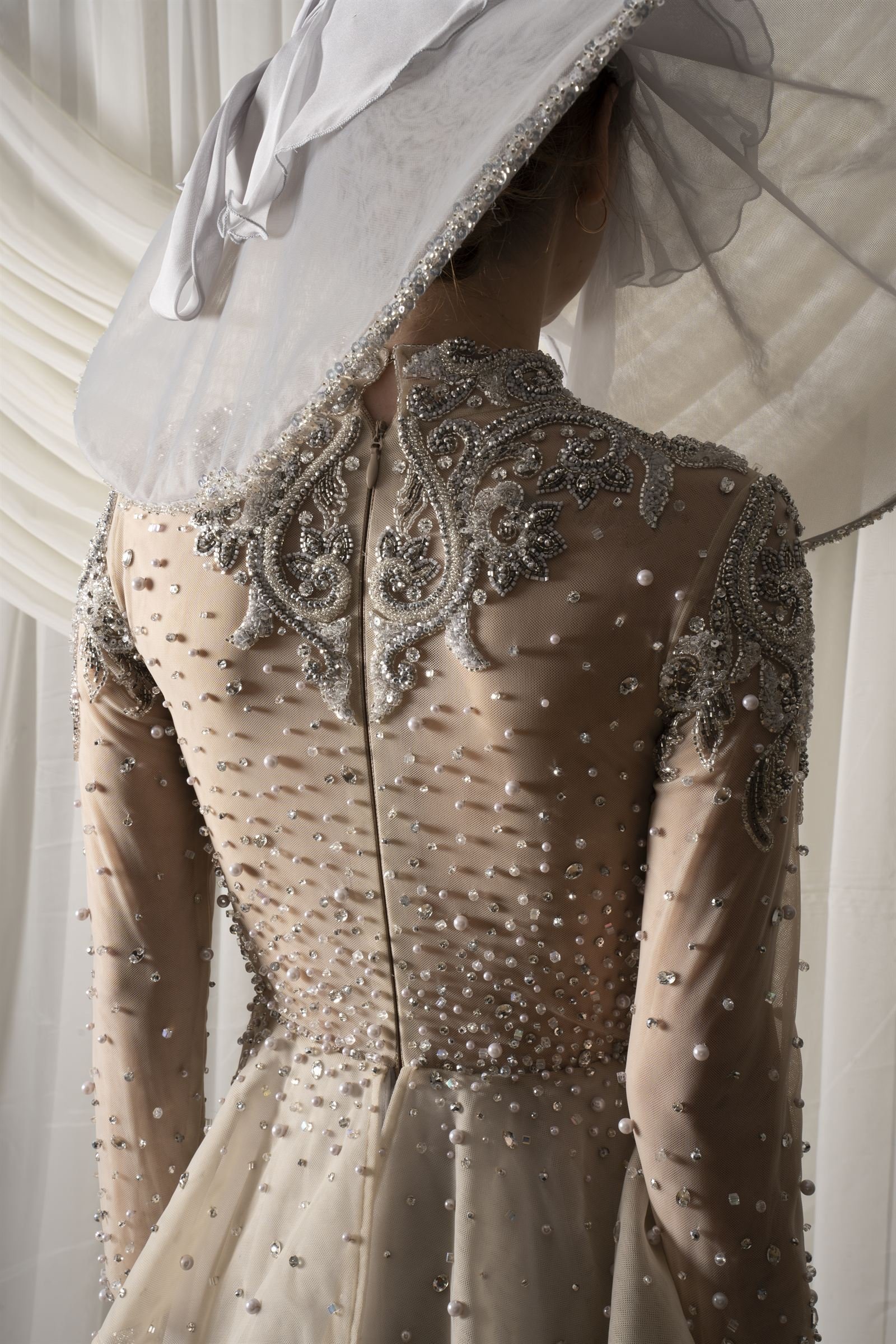 Beaded bodice detail from behind, wide-brim hat