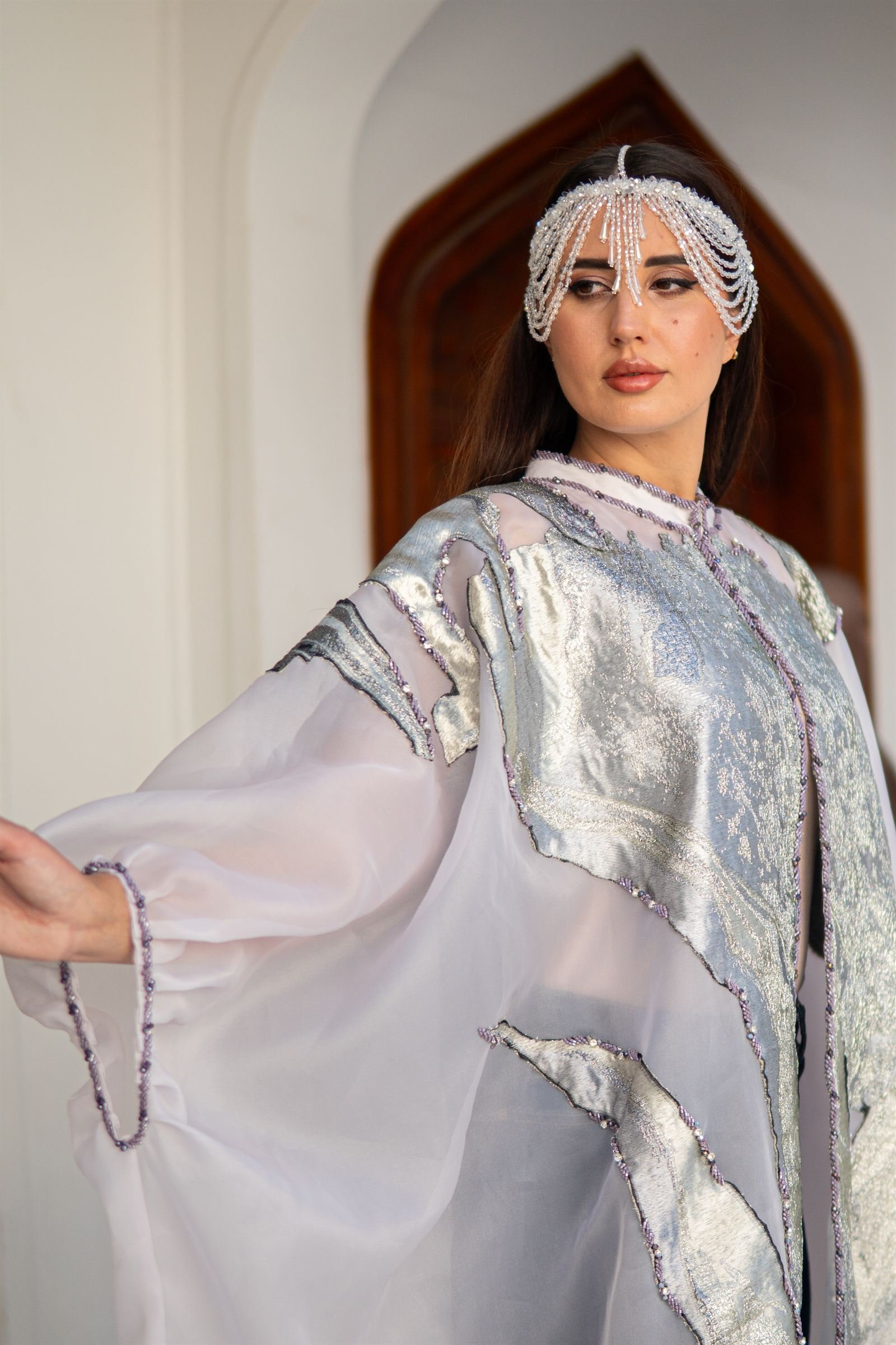 Silver and white kaftan in motion