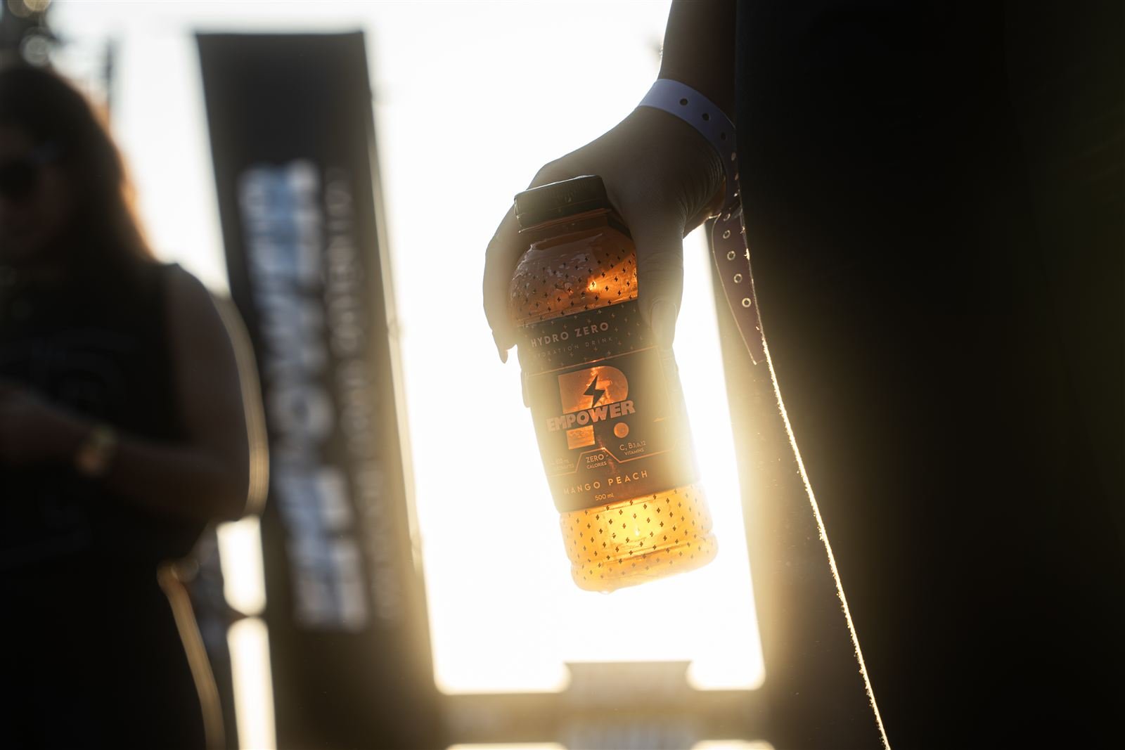 Mango Peach bottle held against the sun flare
