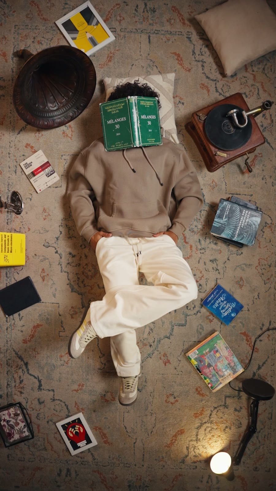 LAYVY — lying on a rug surrounded by props, shot from above